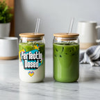 Two iced matcha lattes in glass cups with bamboo lids and straws.