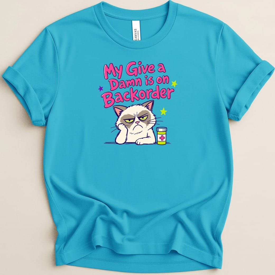 Cyan t-shirt with grumpy cat and pill bottle graphic, reads "My Give a Damn is on Backorder".