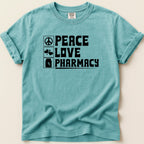 Teal t-shirt with black text "PEACE LOVE PHARMACY" and icons.