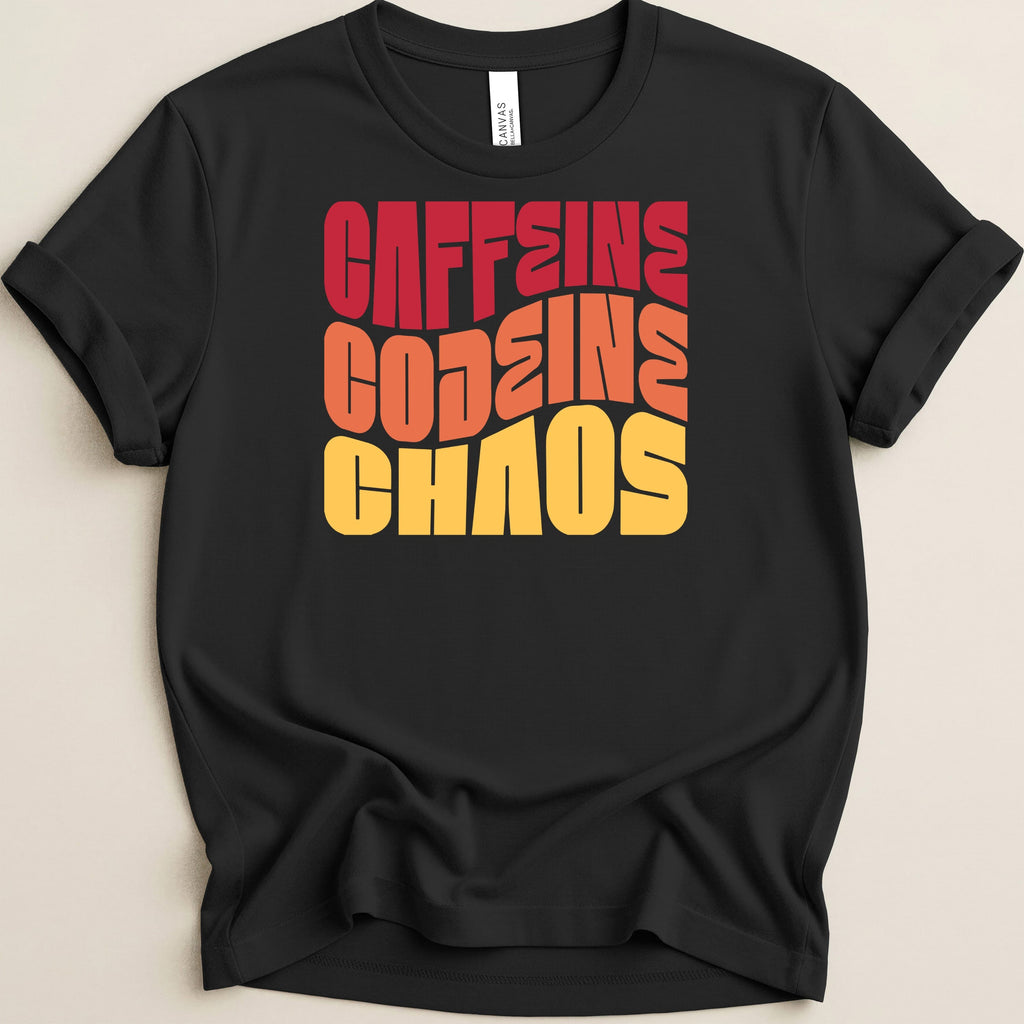 Black t-shirt with bold, wavy red, orange, and yellow text reading "CAFFEINE GODDESS CHAOS".