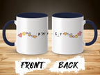 Two mugs with "PHYSICCY" text and colorful cartoon charms on navy handles.