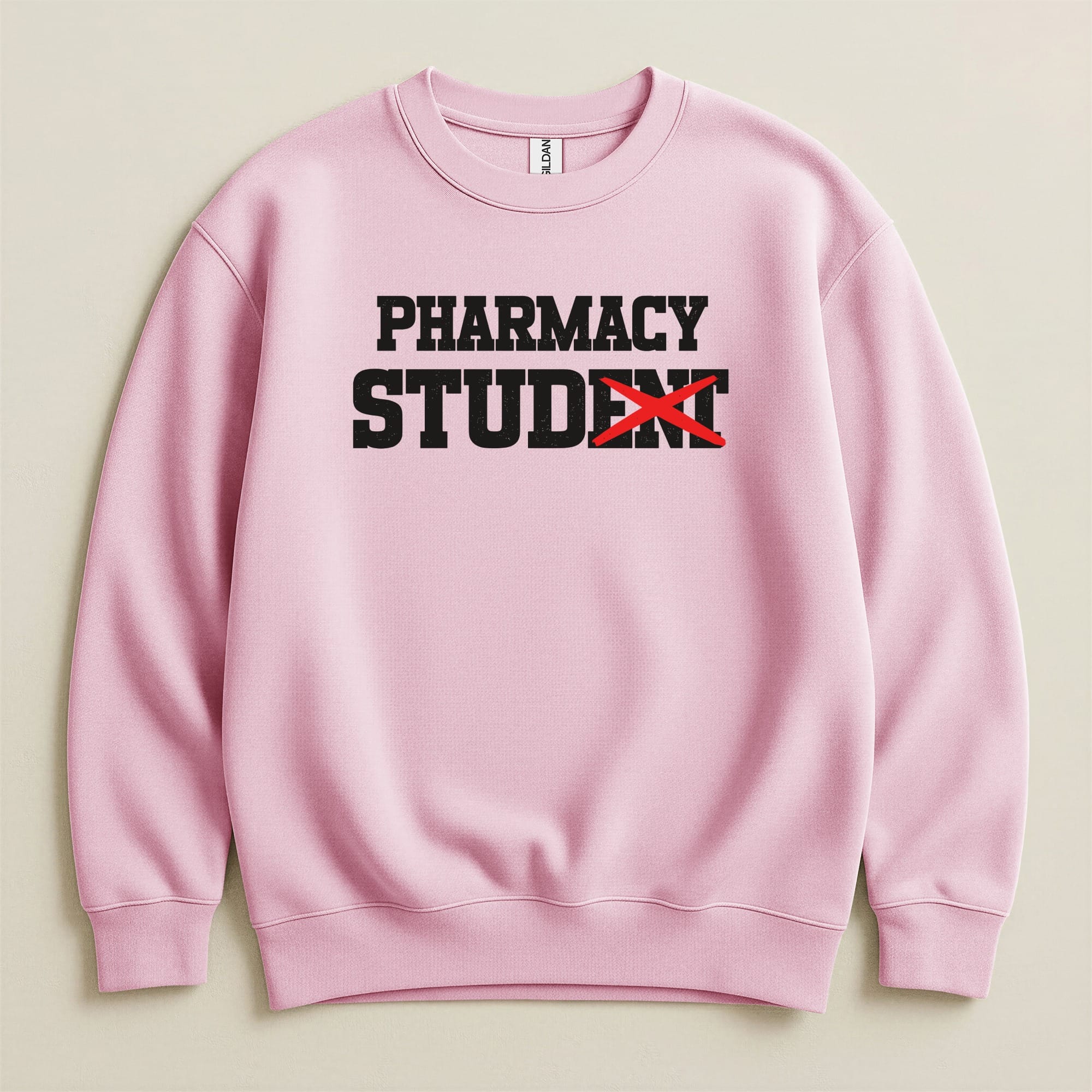 Light pink sweatshirt with "PHARMACY STUDENT" text, the "T" in student is crossed out.