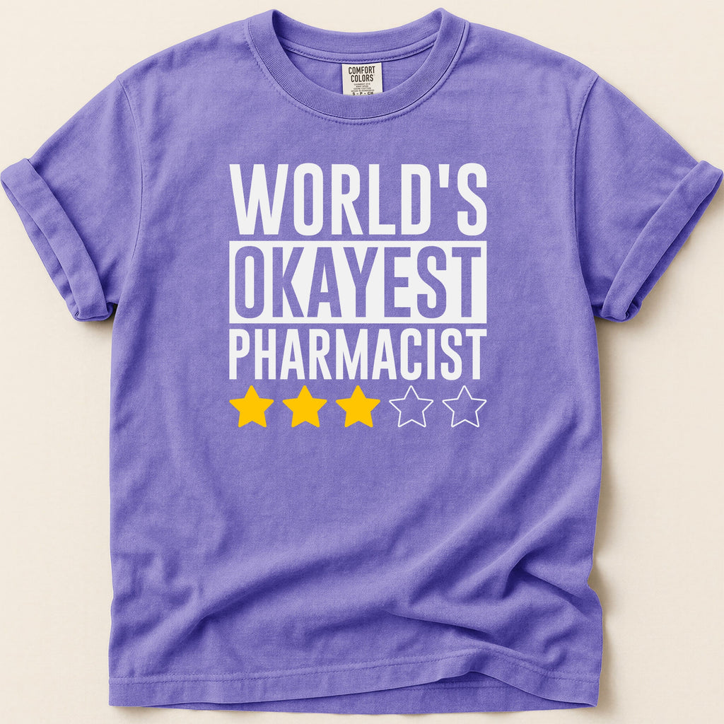 Purple t-shirt with "World's Okayest Pharmacist" and three yellow stars.