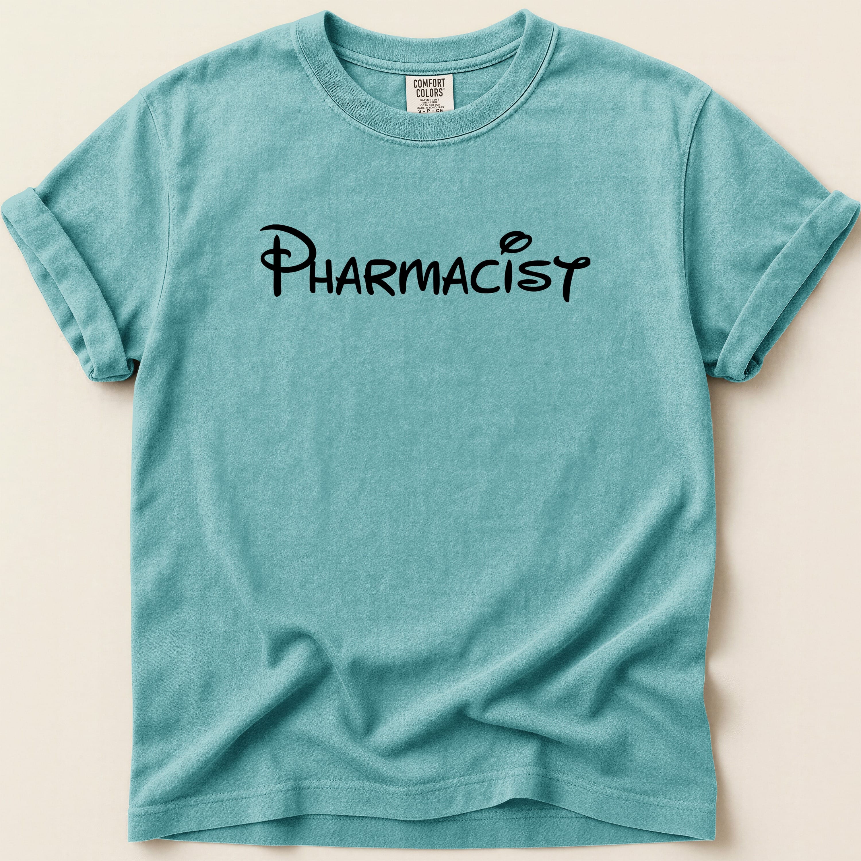 Teal t-shirt with "Pharmacist" in black Disney-style font.