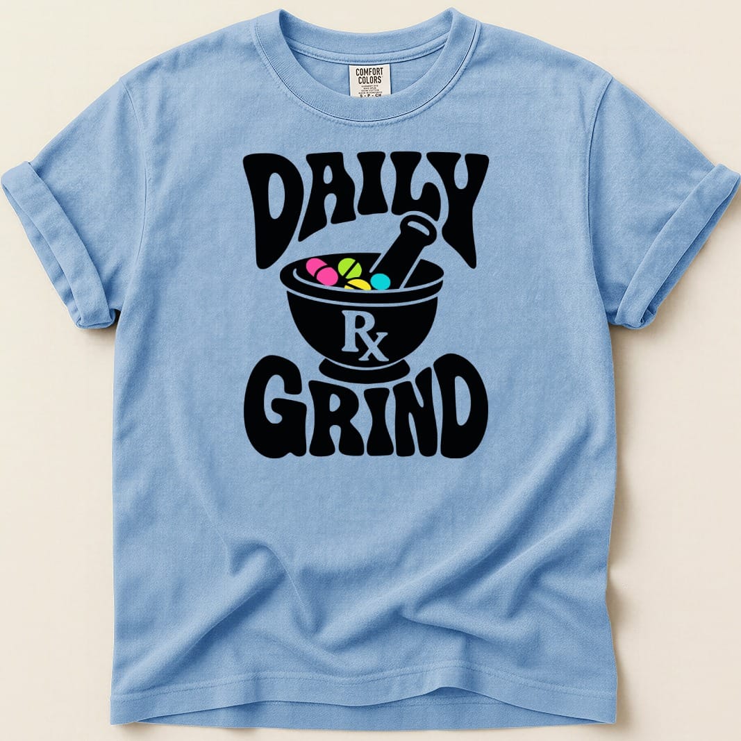Light blue t-shirt with black text and graphic of mortar and pestle with pills.