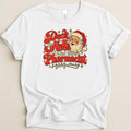 A white short-sleeved t-shirt with a vintage-style graphic featuring Santa Claus and the text "Deck the Halls & Not Your Pharmacist".