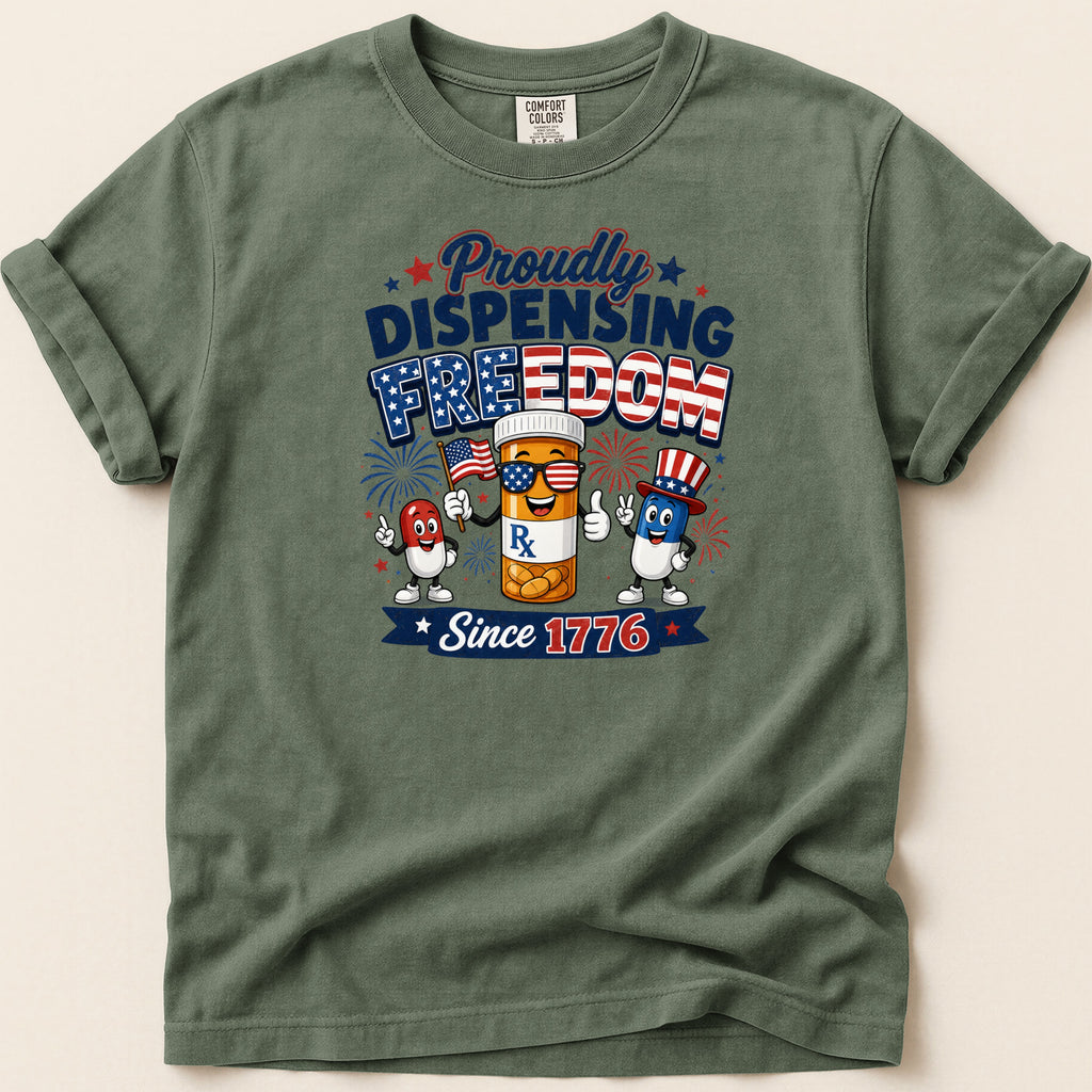 T-shirt with "Proudly Dispensing Freedom Since 1776" text and patriotic pill characters.