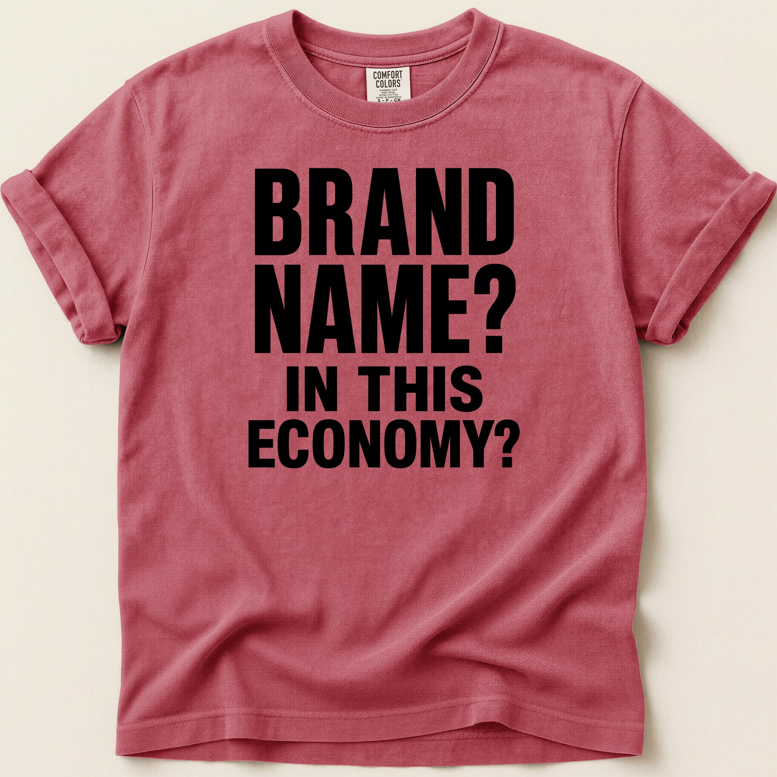 Crimson Comfort Colors t-shirt with "BRAND NAME? IN THIS ECONOMY?" printed in black.