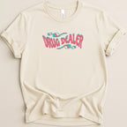 Cream t-shirt with "DRUG DEALER" in wavy pink and blue font.