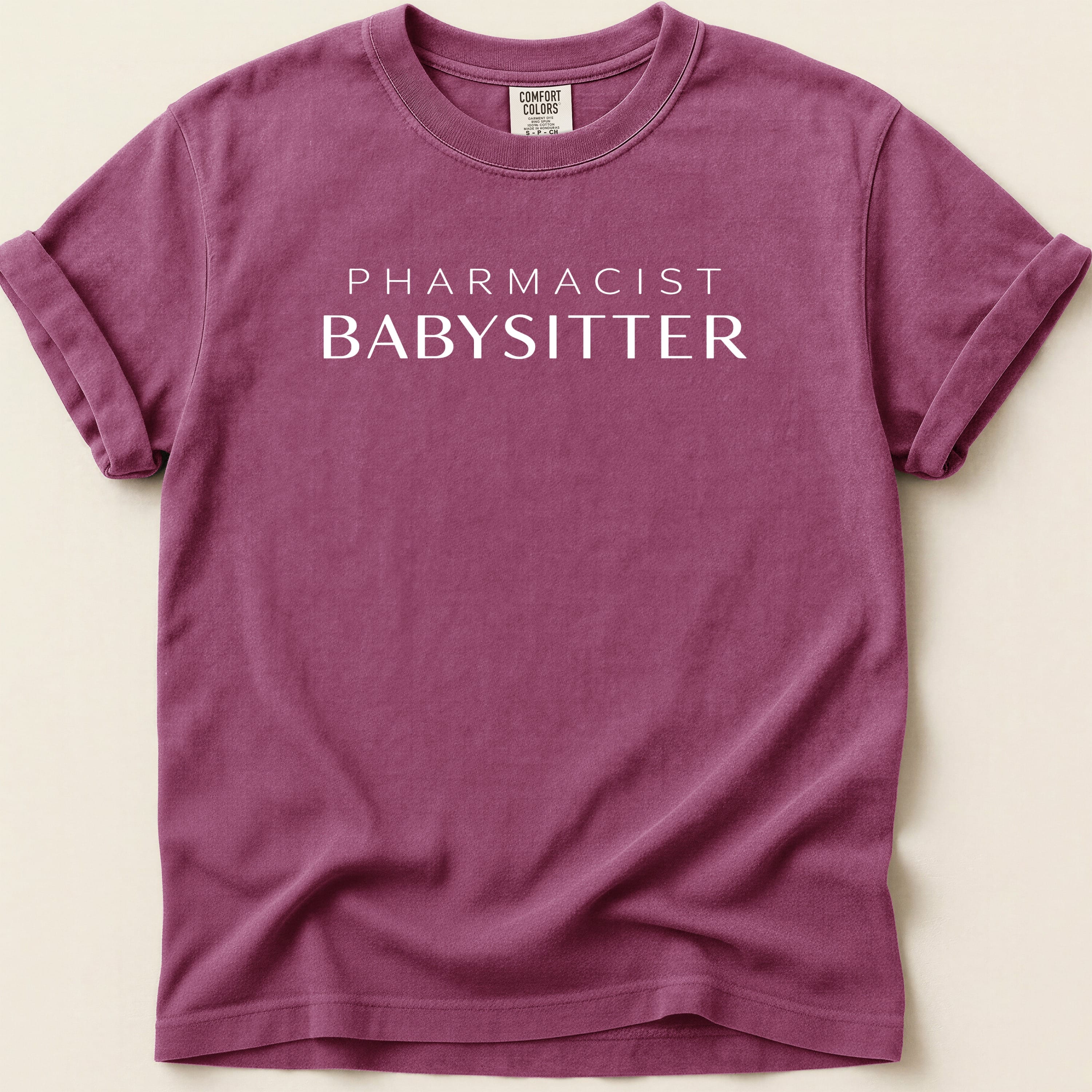 Maroon t-shirt with "PHARMACIST BABYSITTER" in white text.
