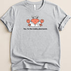 Gray t-shirt with a cartoon crab wearing glasses and a lab coat saying "Yes, I'm the crabby pharmacist."