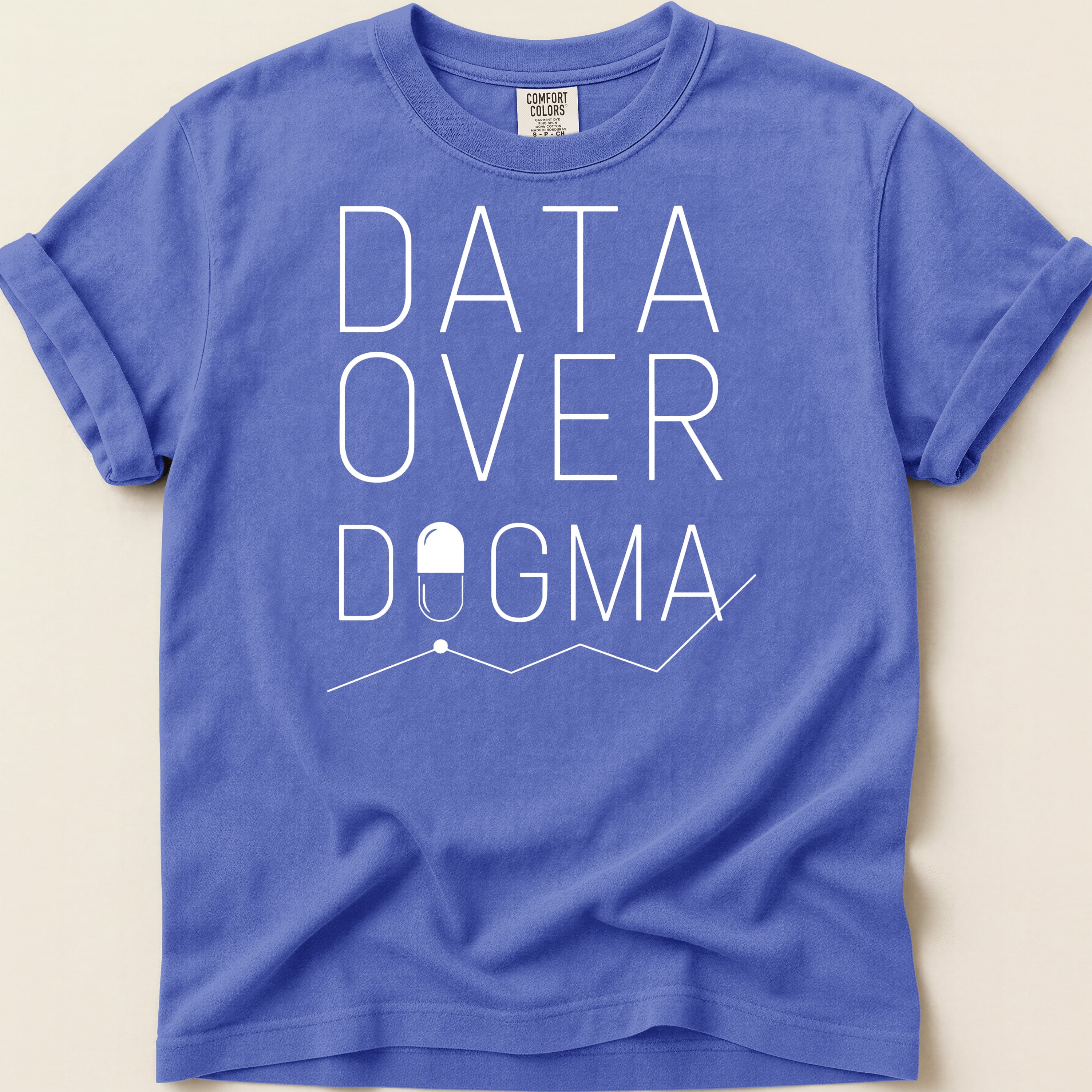 Blue t-shirt with "DATA OVER DOGMA" text and pill graphic.