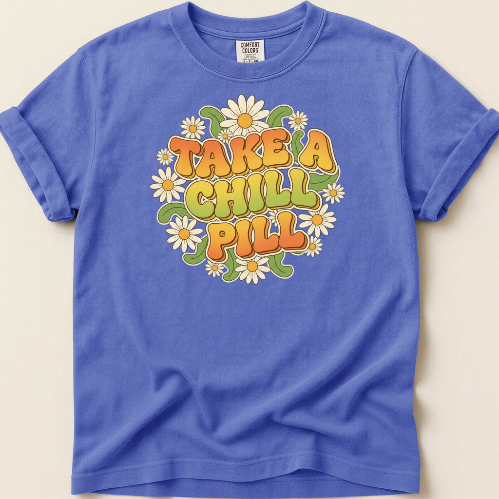 T-shirt with "TAKE A CHILL PILL" text surrounded by daisies.