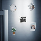 "Certified Pharmacist Babysitter" magnet on a refrigerator door.