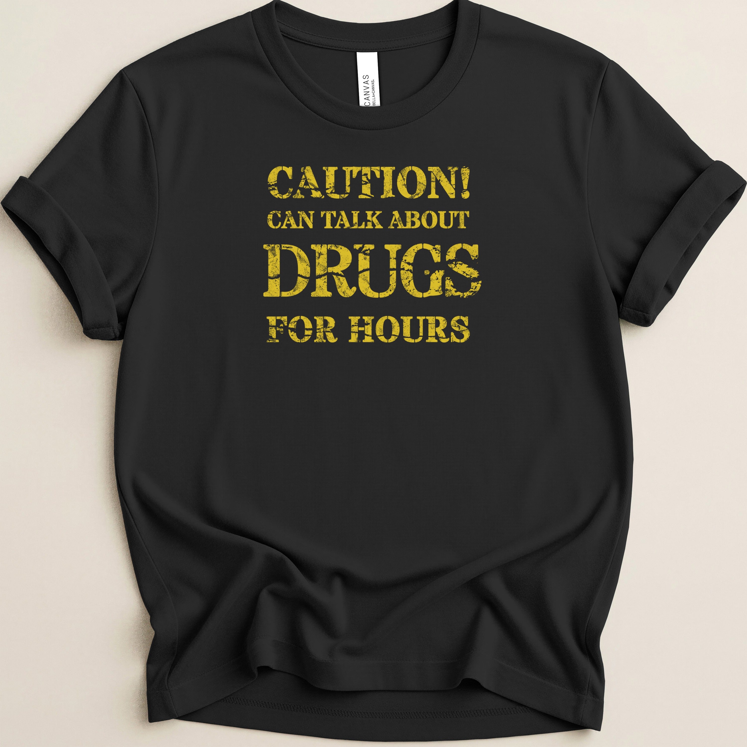 Black t-shirt with yellow distressed text: "CAUTION! CAN TALK ABOUT DRUGS FOR HOURS"