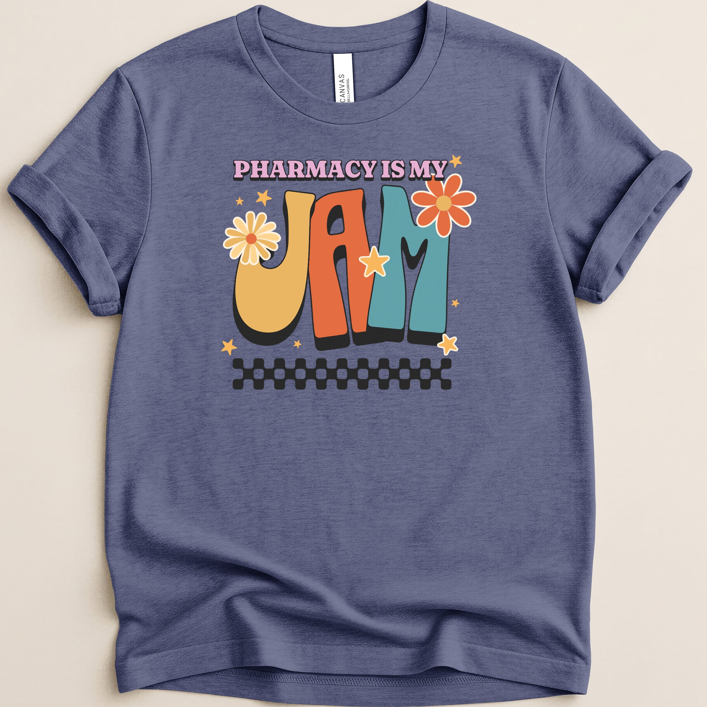 T-shirt with "Pharmacy is my jam" text, colorful lettering, and floral accents.