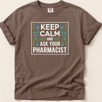 Brown t-shirt with "KEEP CALM AND ASK YOUR PHARMACIST" text and pharmacy symbols.