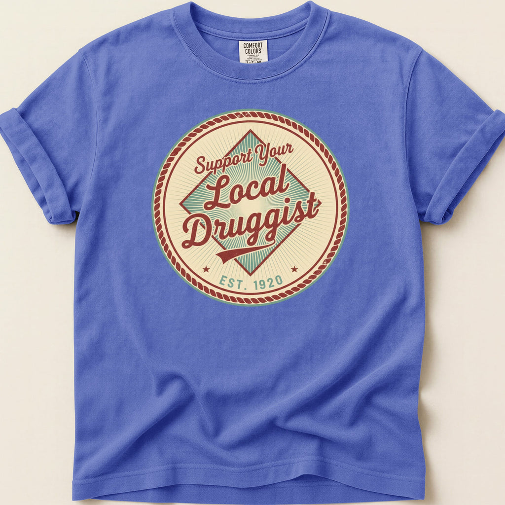 Blue t-shirt with "Support Your Local Druggist Est. 1920" circular logo.