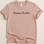 Pink t-shirt with "Pharmacy Technician" in stylized black font.