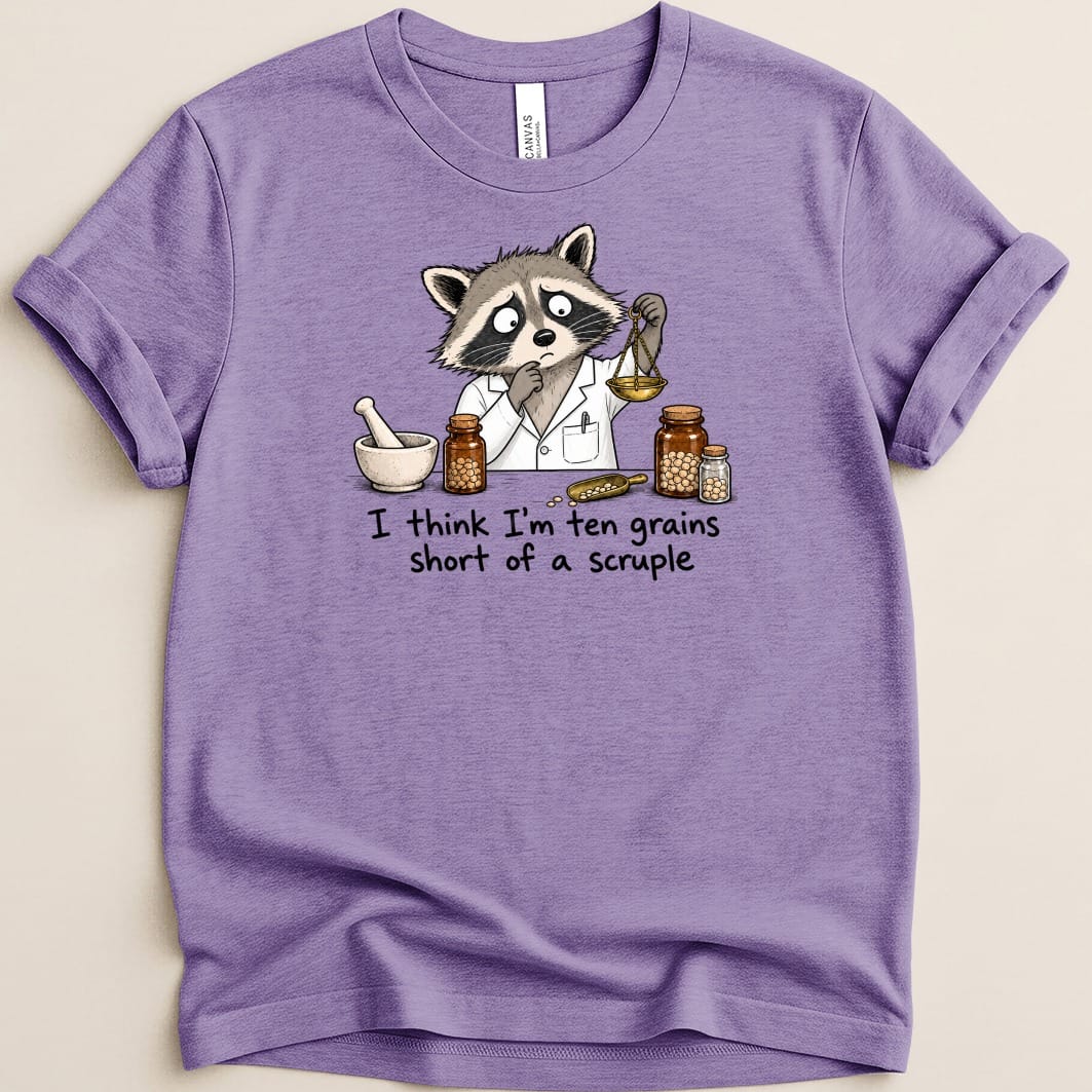 Raccoon in lab coat weighing grains, "I think I'm ten grains short of a scruple" text.