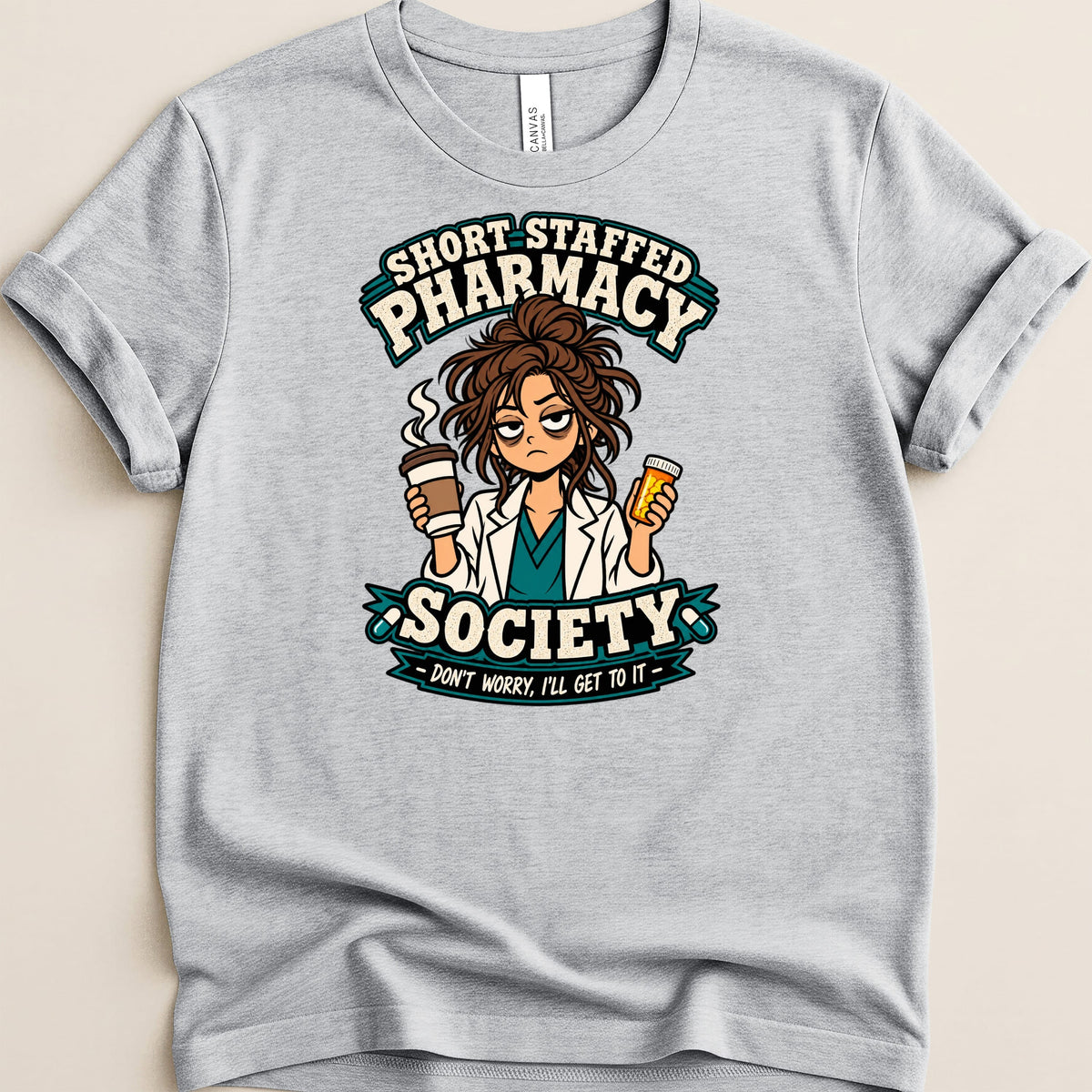 Grey t-shirt with "Short Staffed Pharmacy Society" and a tired pharmacist graphic.