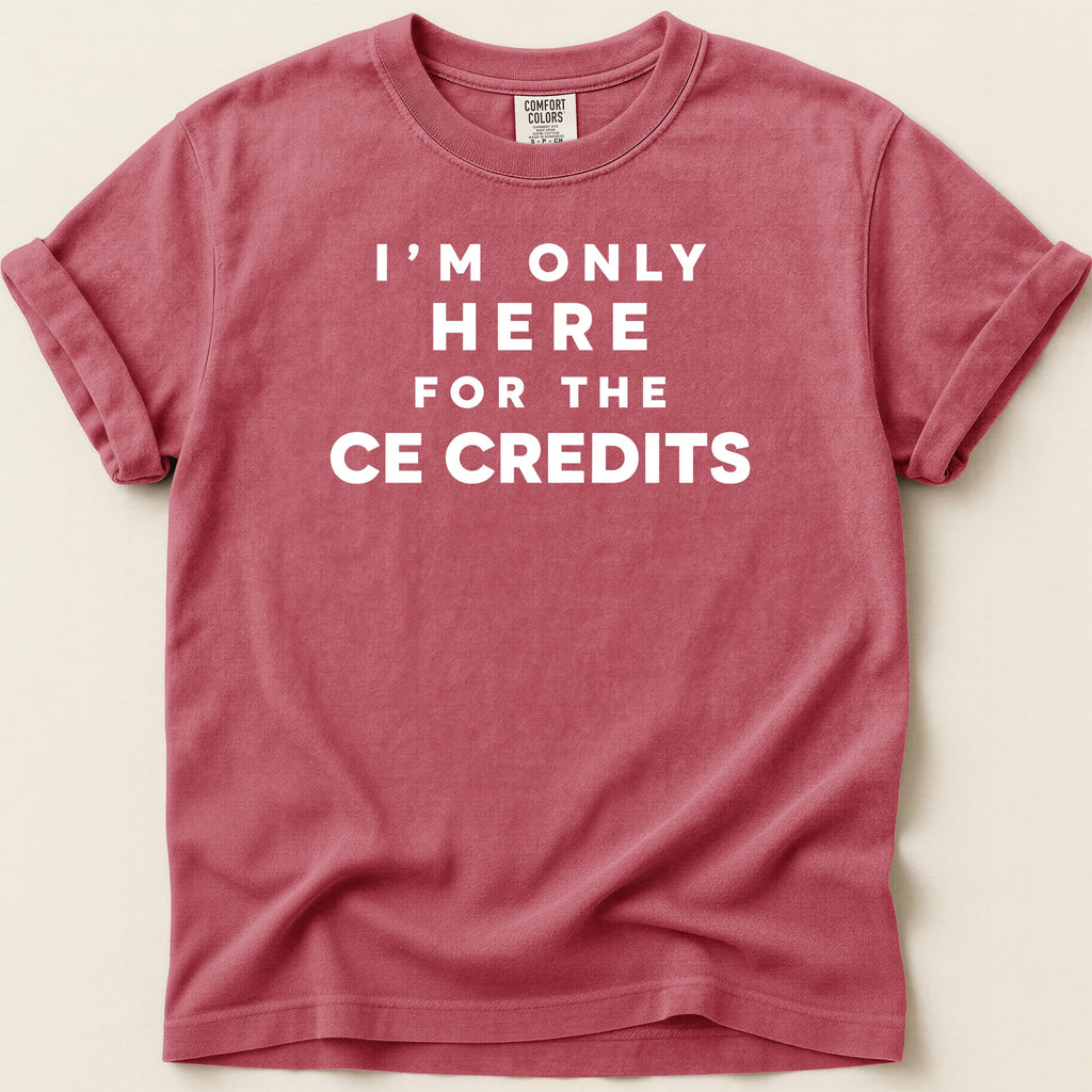 Red Comfort Colors t-shirt with white text reading "I'M ONLY HERE FOR THE CE CREDITS".