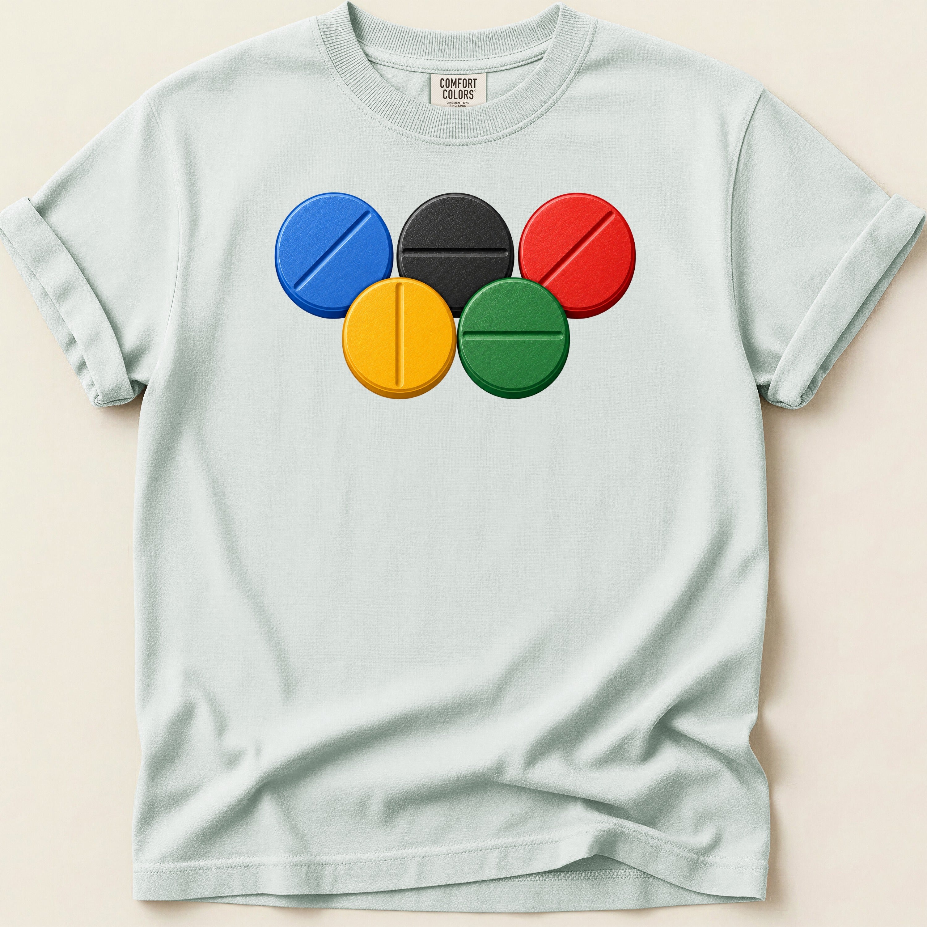 Light blue t-shirt with Comfort Colors tag and five colorful Olympic-style rings.