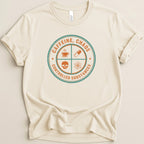 Cream t-shirt with circular graphic featuring text and icons.