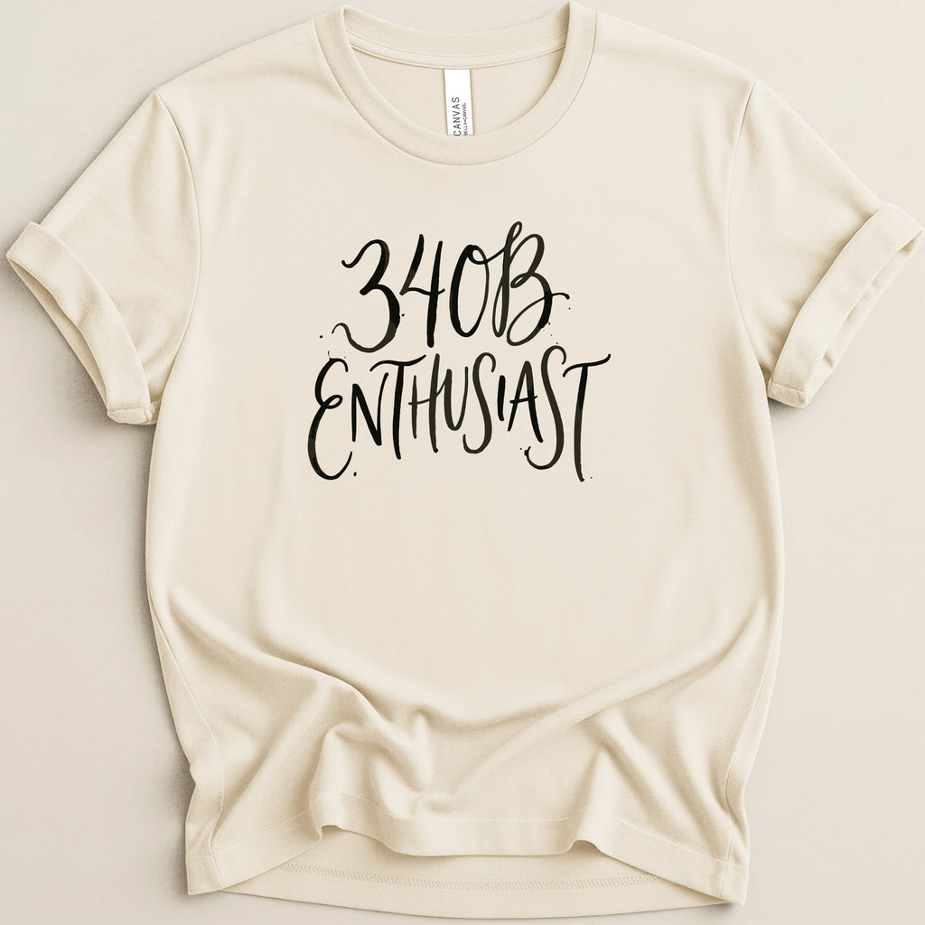 Cream t-shirt with "34B Enthusiast" in black script text.