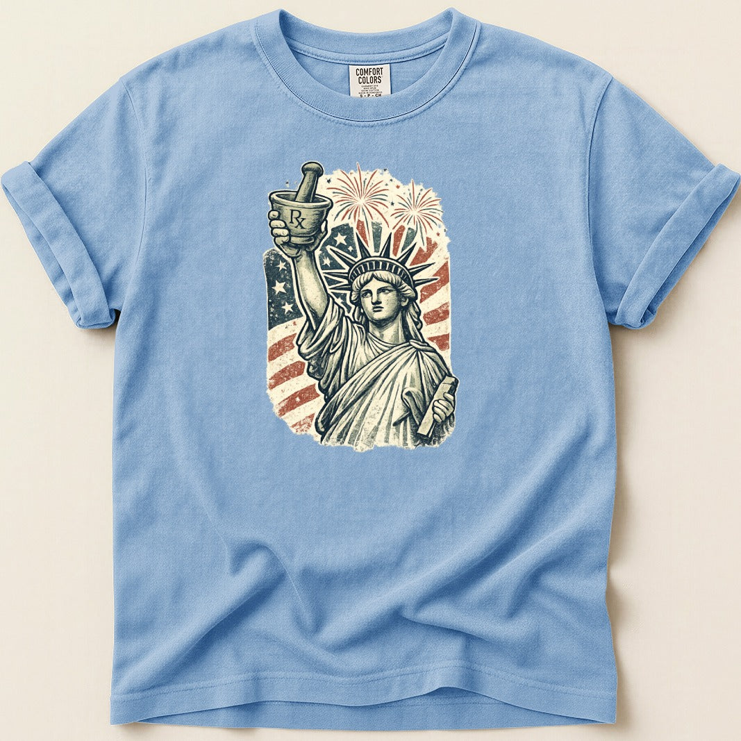 Statue of Liberty holding mortar and pestle with fireworks and US flag.