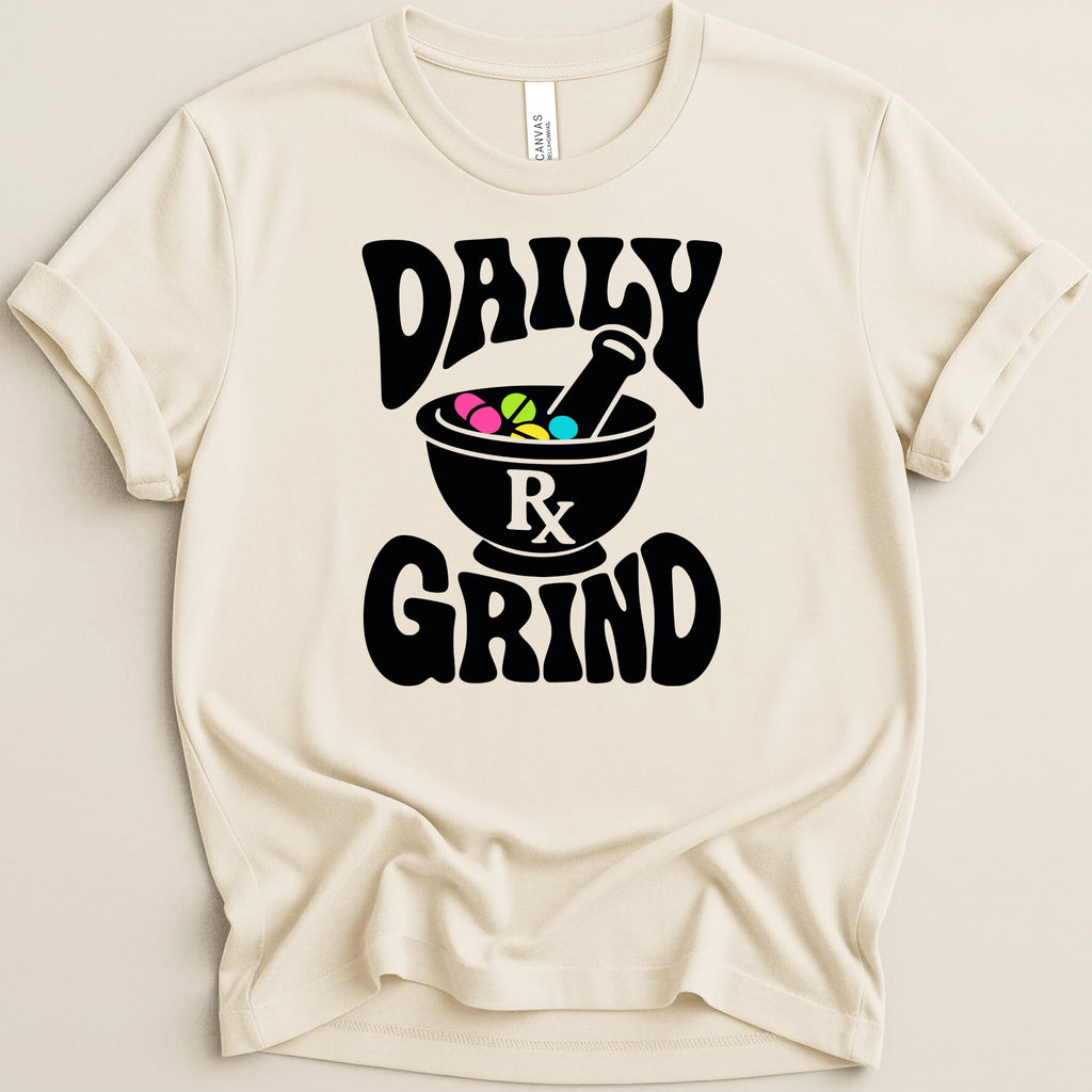 Cream t-shirt with black "DAILY" and "GRIND" text and a mortar and pestle with pills.