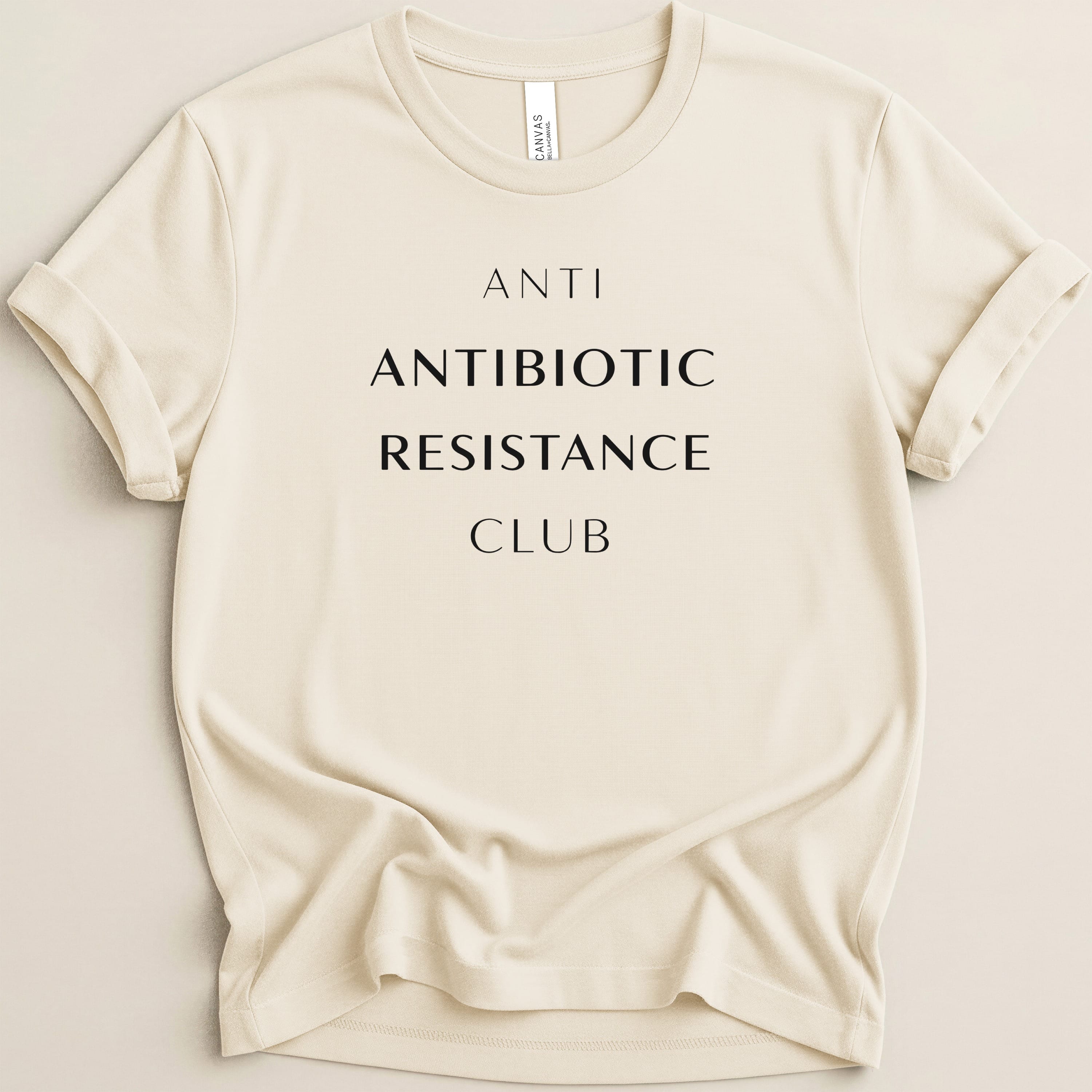 Cream t-shirt with "ANTI ANTIBIOTIC RESISTANCE CLUB" in black text.