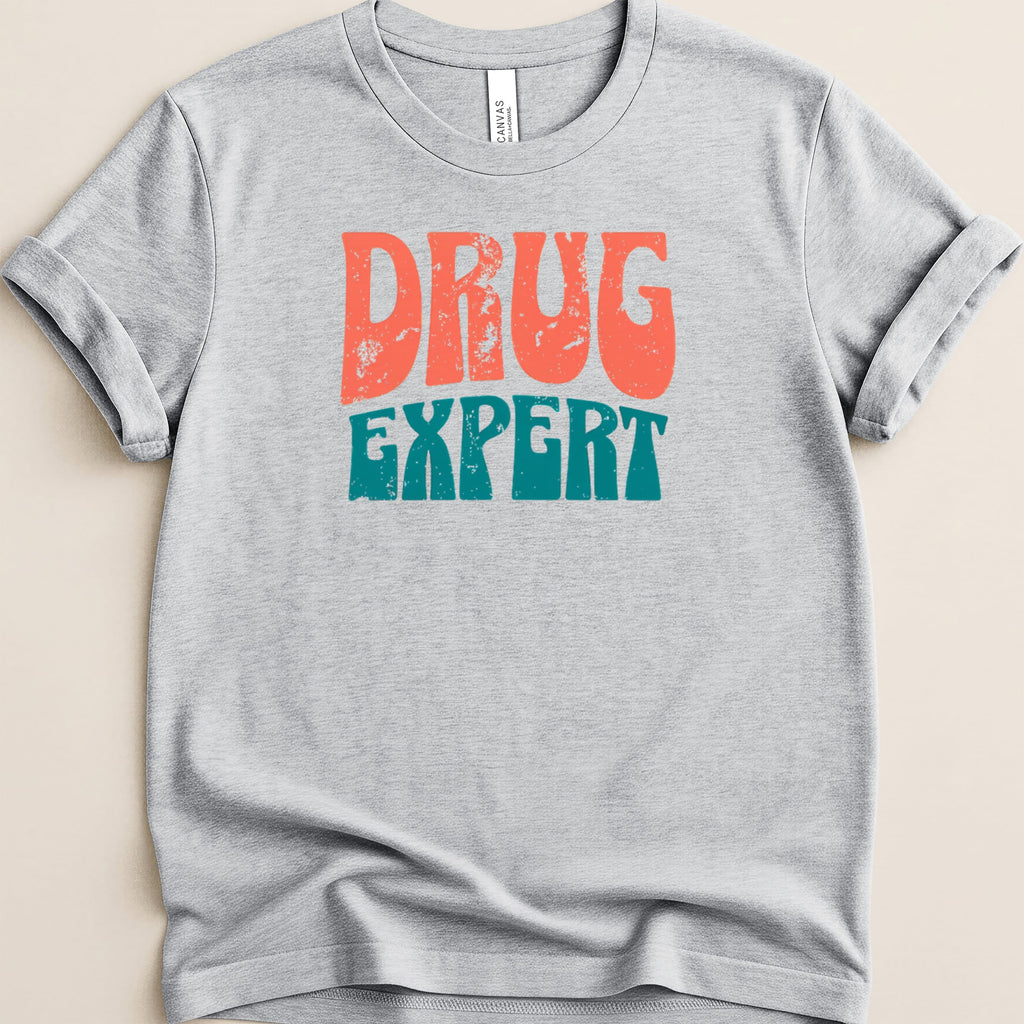 Gray t-shirt with "DRUG EXPERT" in distressed orange and teal text.