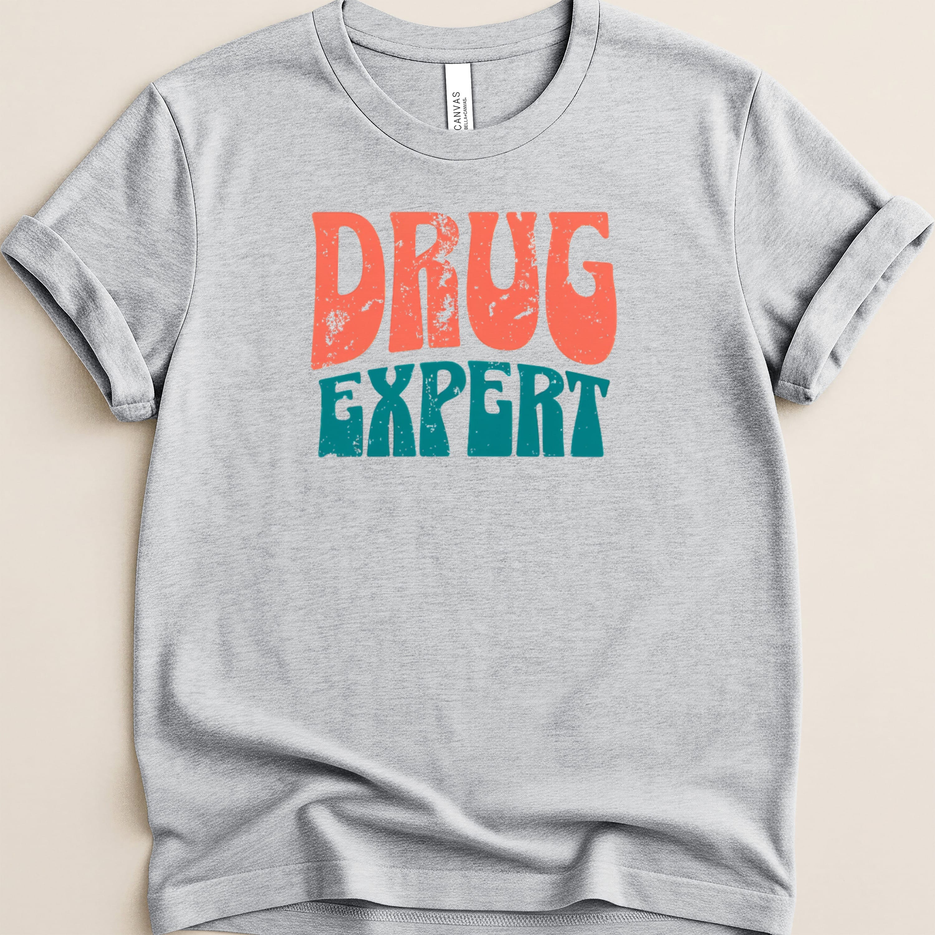 Gray t-shirt with "DRUG EXPERT" in distressed orange and teal text.