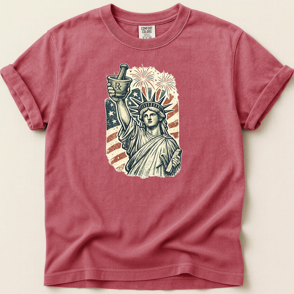 Statue of Liberty holding mortar and pestle with fireworks and American flag.