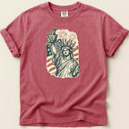 Statue of Liberty holding mortar and pestle with fireworks and American flag.