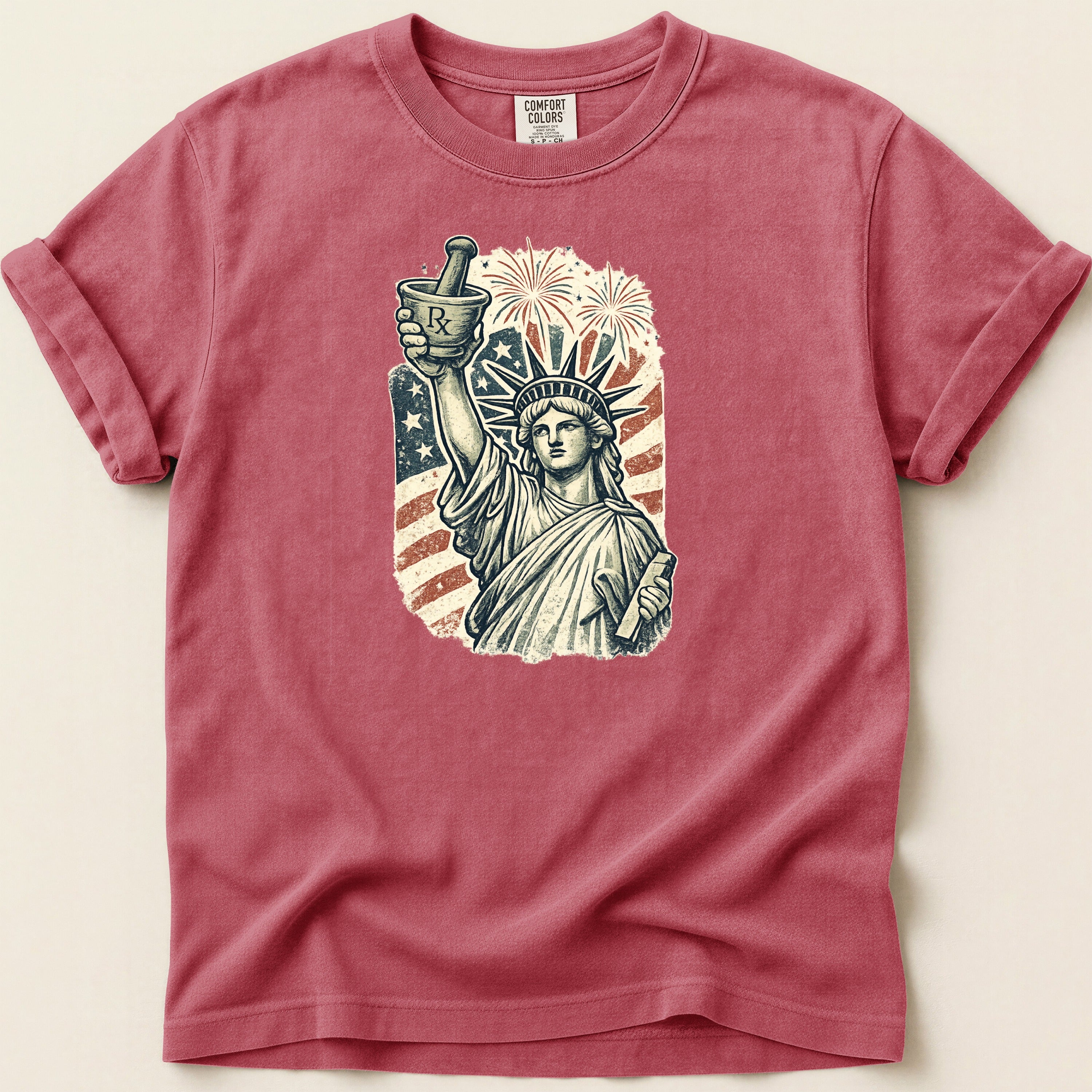 Statue of Liberty holding mortar and pestle with fireworks and American flag.