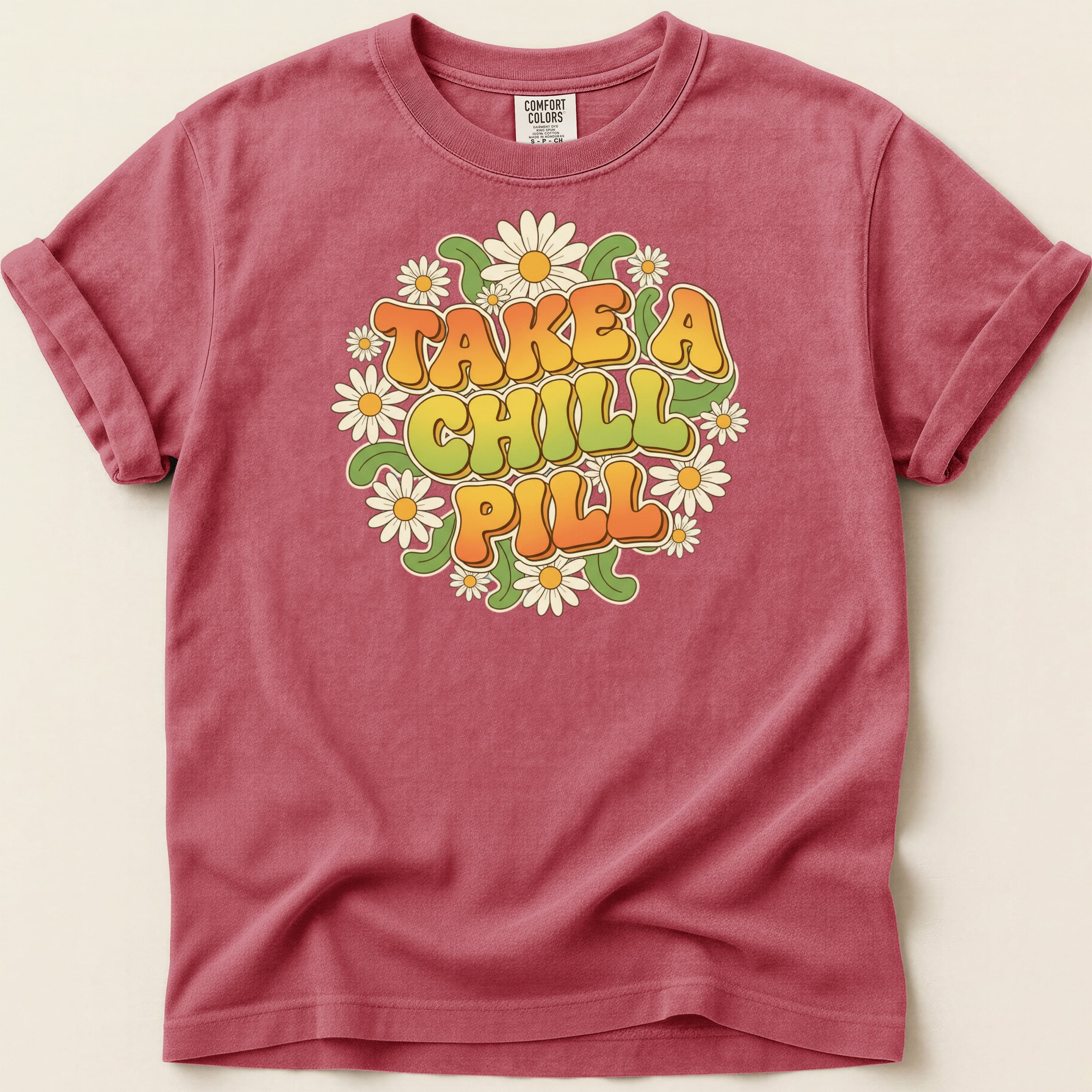 T-shirt with "Take a Chill Pill" and daisy graphic.