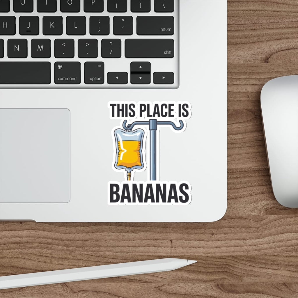 Sticker with IV bag labeled "THIS PLACE IS BANANAS" on a laptop.