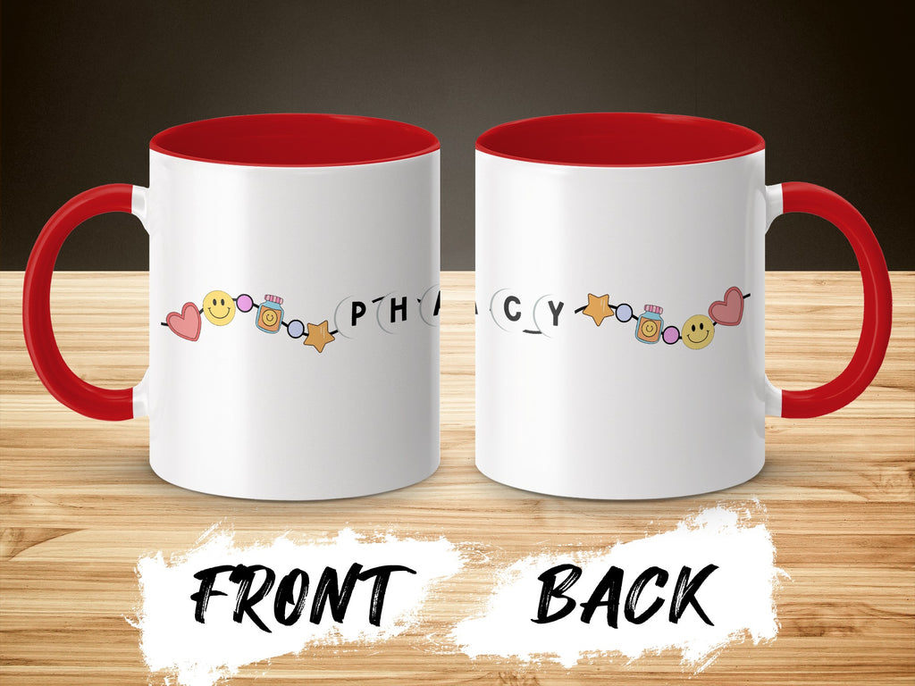 White mug with red handle and interior, featuring smiling faces and "Pharmacy" text.