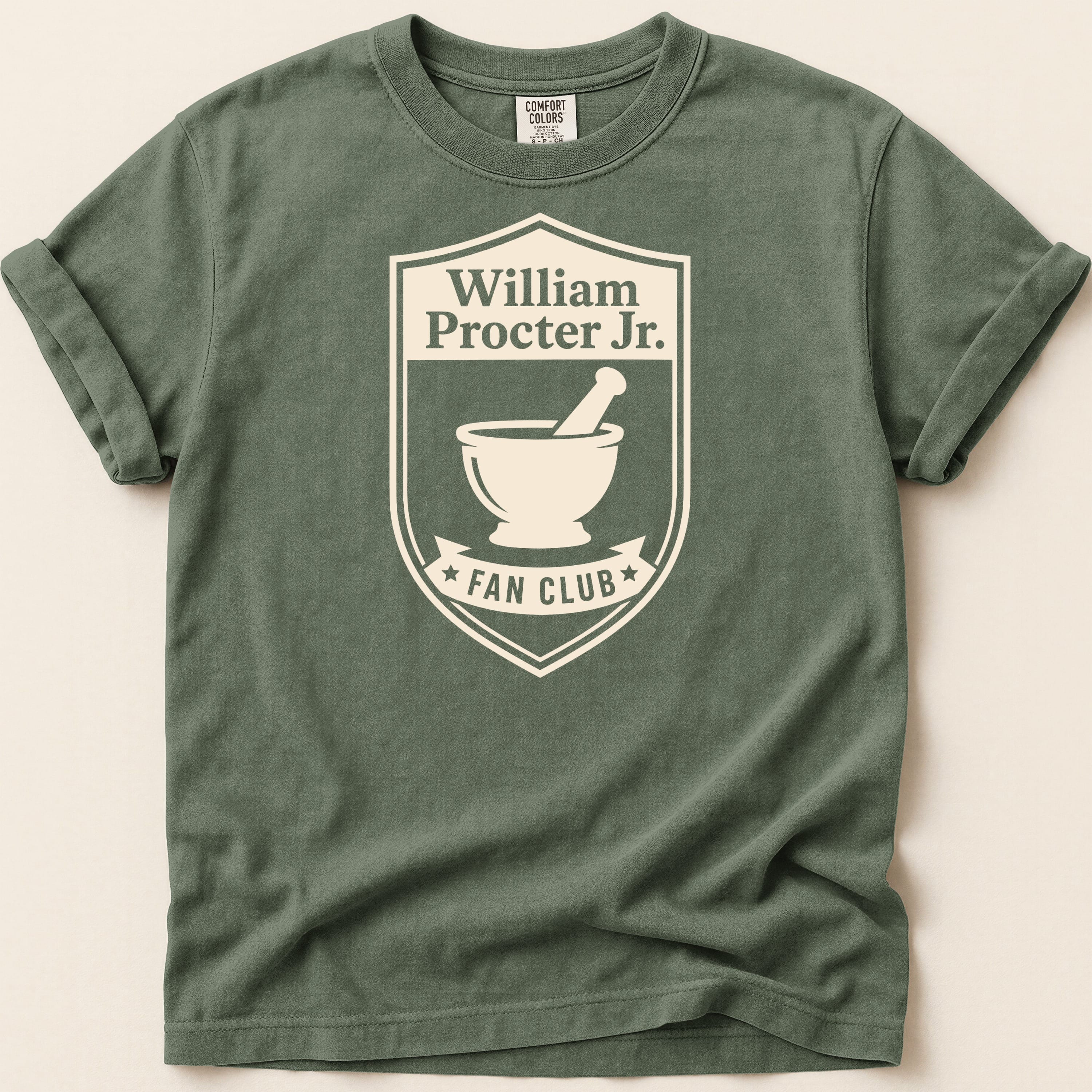 T-shirt featuring a crest with "William Procter Jr. FAN CLUB" and a mortar and pestle.