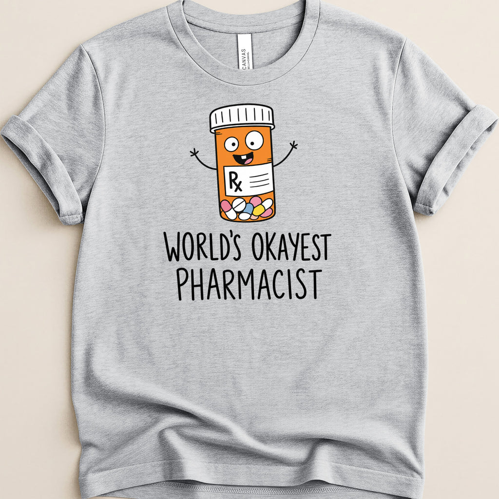 Gray t-shirt with cartoon prescription bottle and "World's Okayest Pharmacist" text.