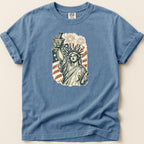 Statue of Liberty holding mortar and pestle with American flag and fireworks.