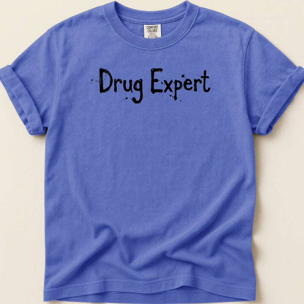 Purple t-shirt with "Drug Expert" text in black spray paint font.