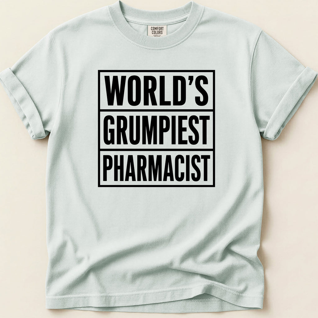 Light blue t-shirt with black text "WORLD'S GRUMPIEST PHARMACIST".