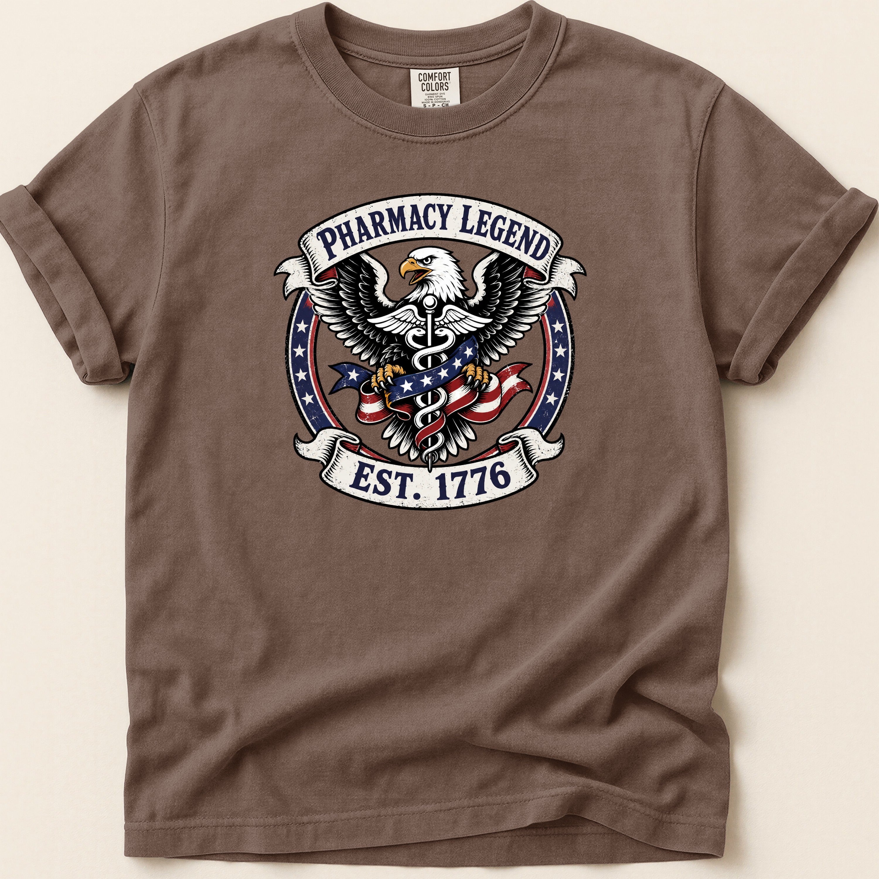 Brown t-shirt with Pharmacy Legend EST. 1776 eagle emblem.
