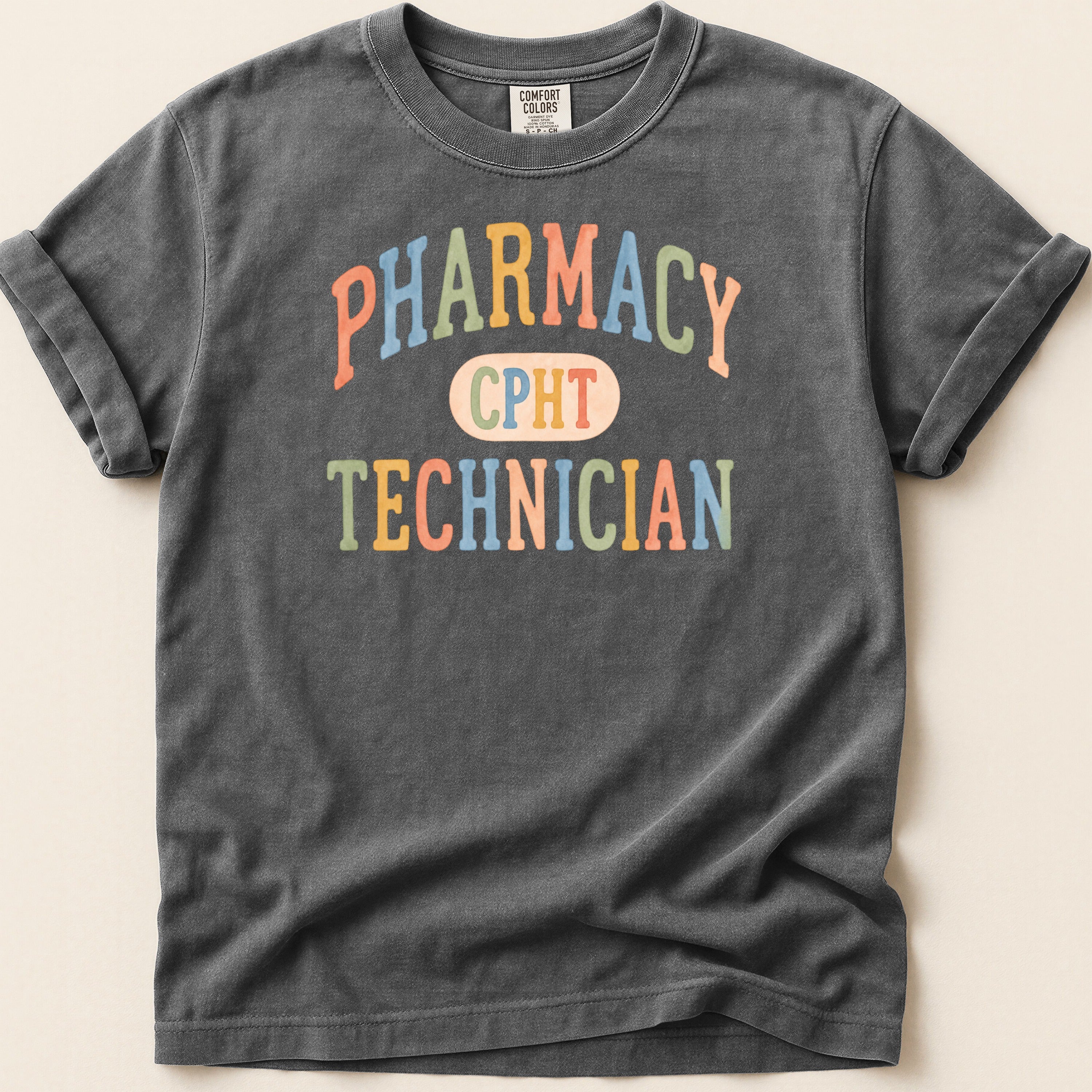 Dark gray t-shirt with "PHARMACY CPHT TECHNICIAN" text in colorful lettering.
