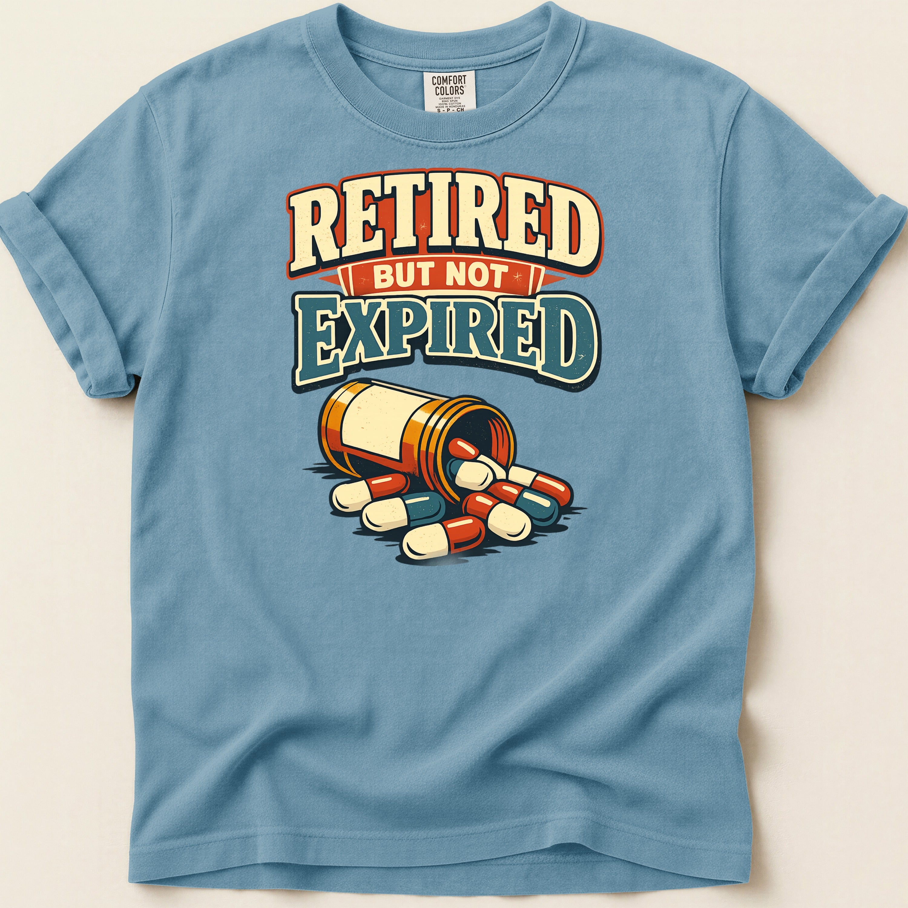 Blue t-shirt with "Retired But Not Expired" text and a pill bottle.
