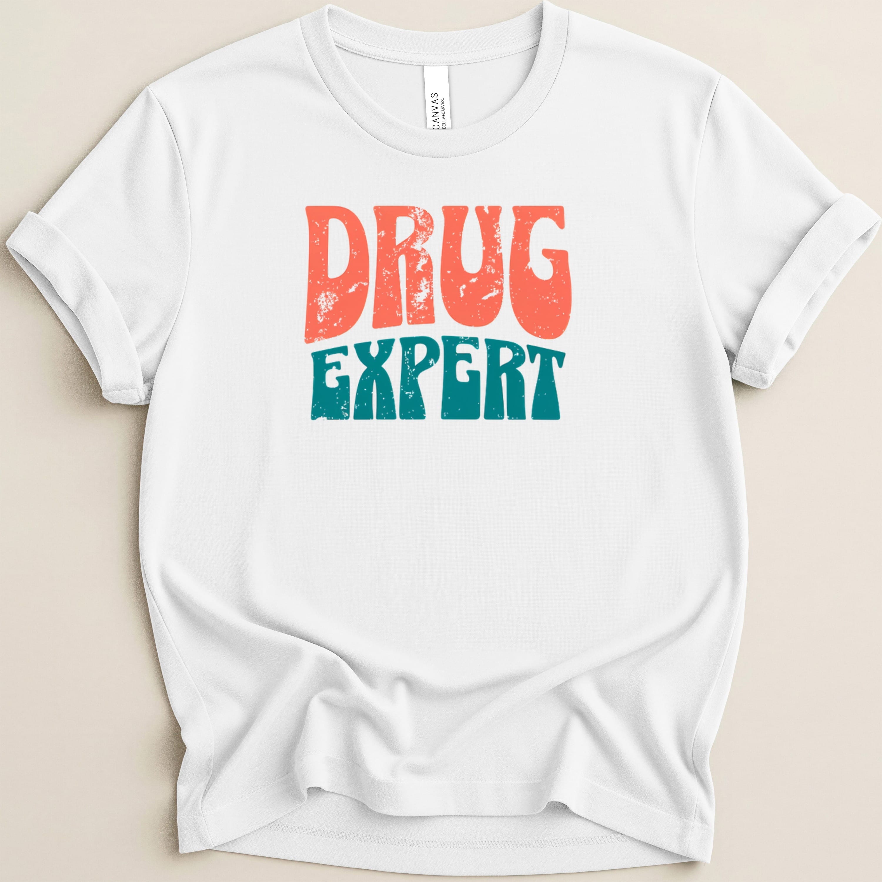 White t-shirt with distressed text "DRUG EXPERT" in coral and teal.