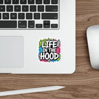 Sticker with "Life in the Hood" text and graffiti spray cans.